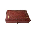 Antique rectangular red leather case with gold decorative border detailing and corner accents, shown on a plain white background.